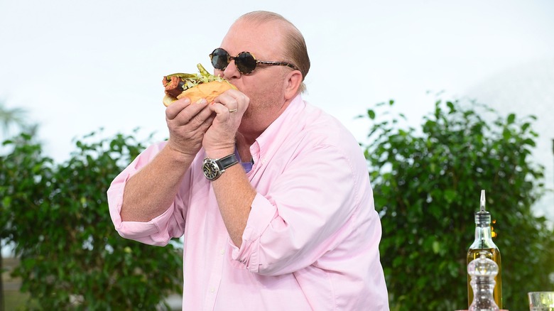 Mario Batali eating a sandwich