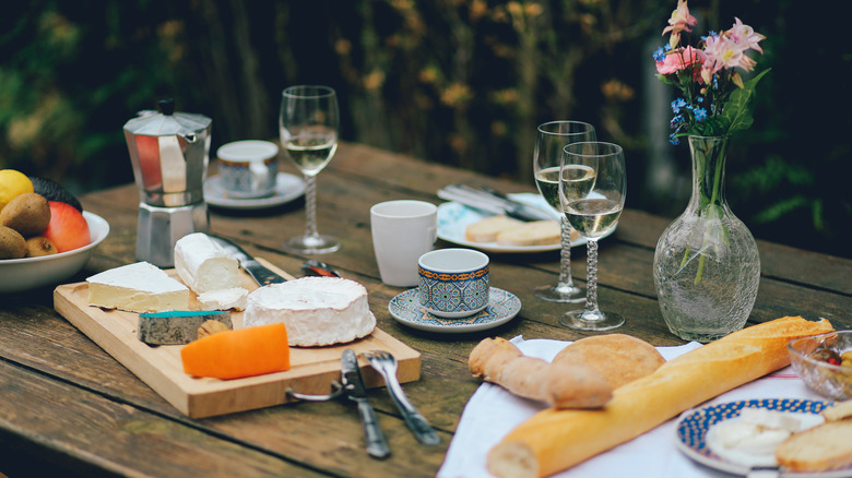 table with cheese, bread, wine