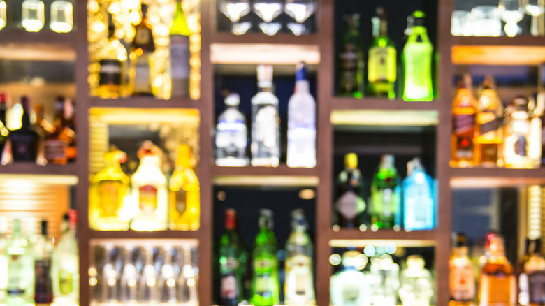 liquor bottles backlit on a bar