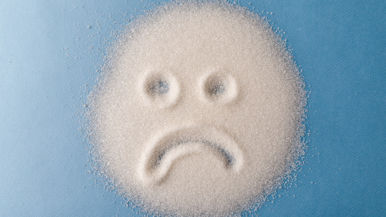 Sad face drawn in sugar