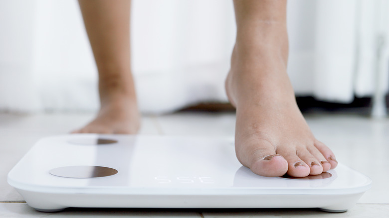 Person stepping on bathroom scale