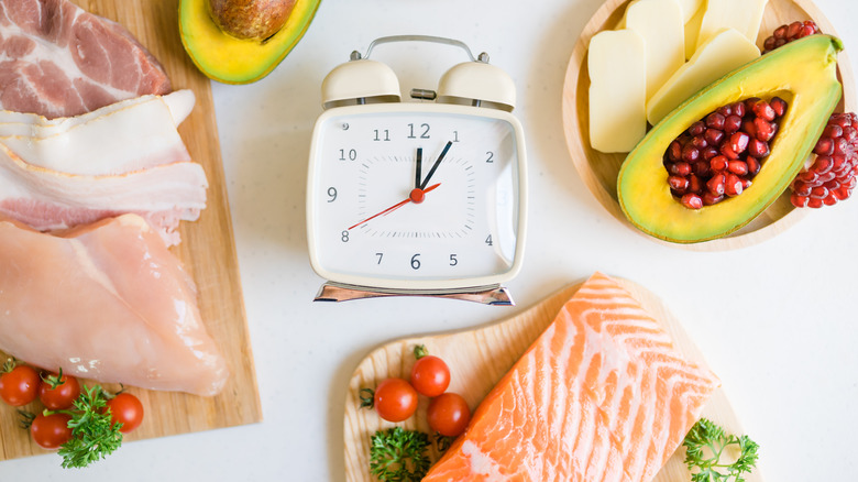 clock surrounded by healthy foods