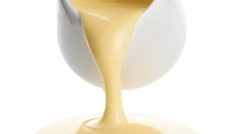 white jar pouring condensed milk 