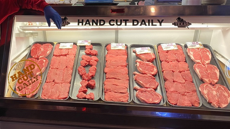 A meat counter displaying fresh cuts of steak