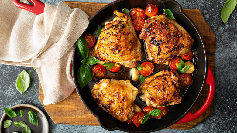 Cooked chicken thighs in skillet