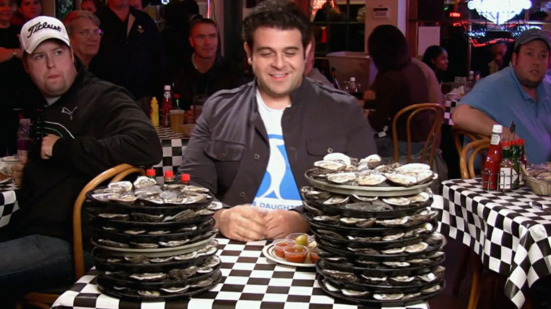 adam richman smiling at oysters