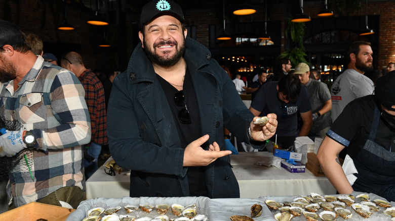 adam richman posing with oysters