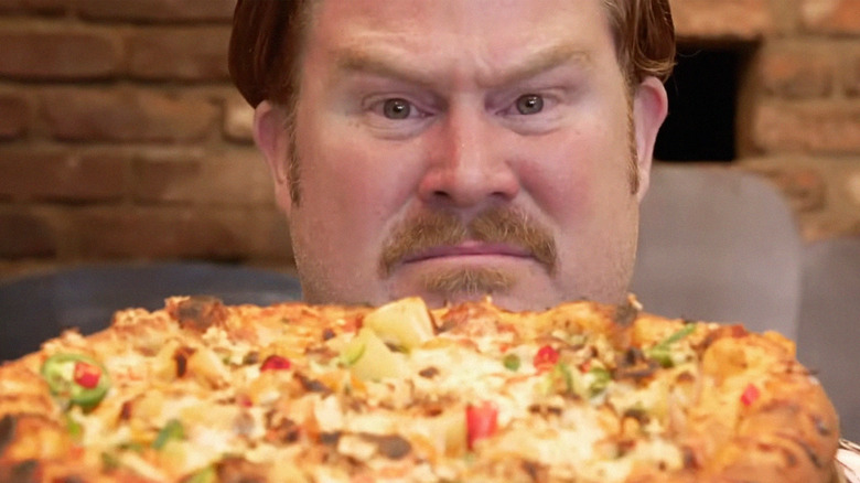 casey webb scowling at pizza