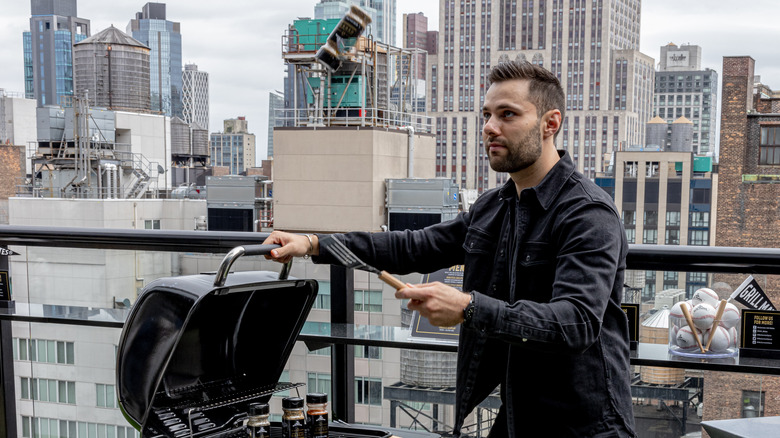 Max Greb flipping seasoning into air with spatula