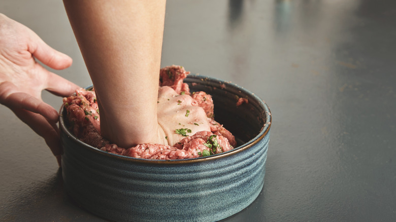 Hand kneading ground beef