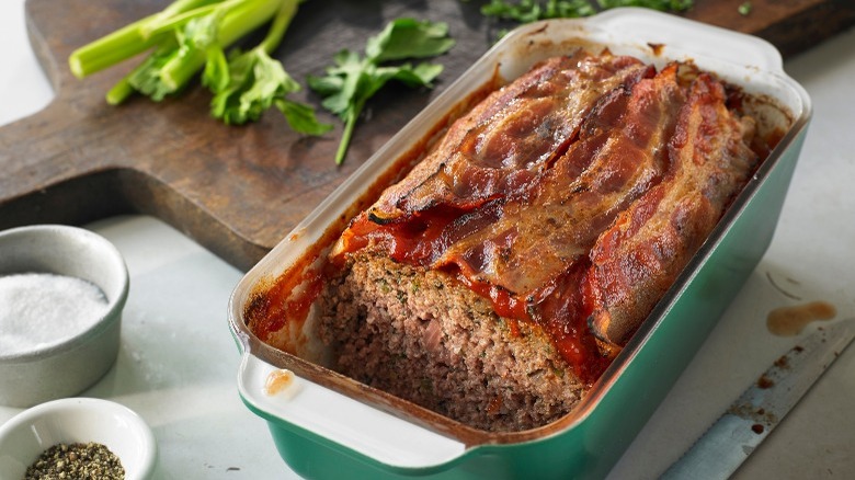 meatloaf with veggies in the background