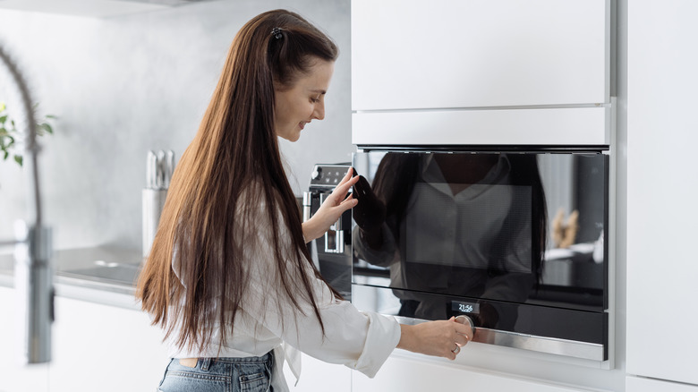 woman setting oven temperature