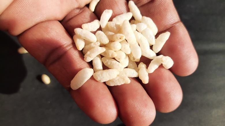 hand pouring out puffed rice