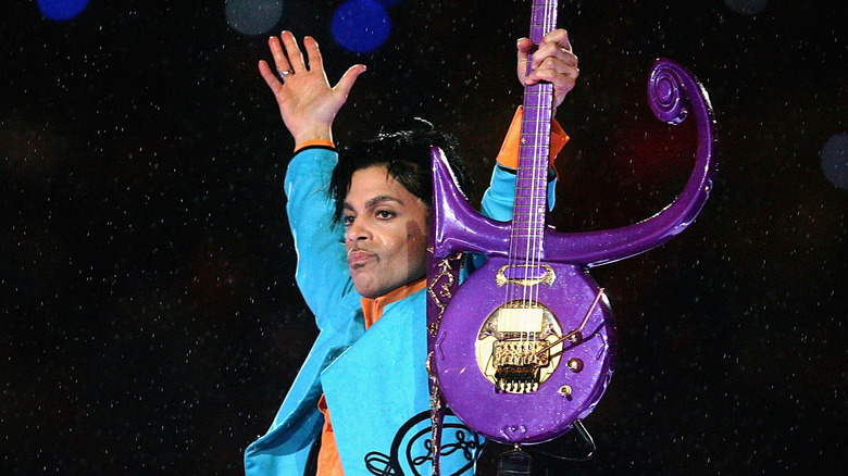 Prince holding guitar