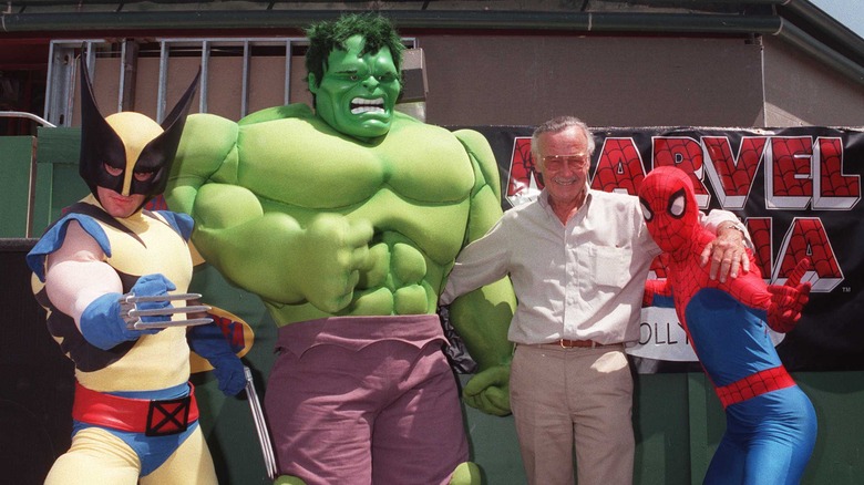 Stan Lee and characters posing outside restaurant