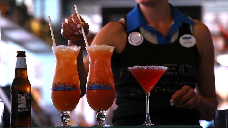 bartender placing straw in drink