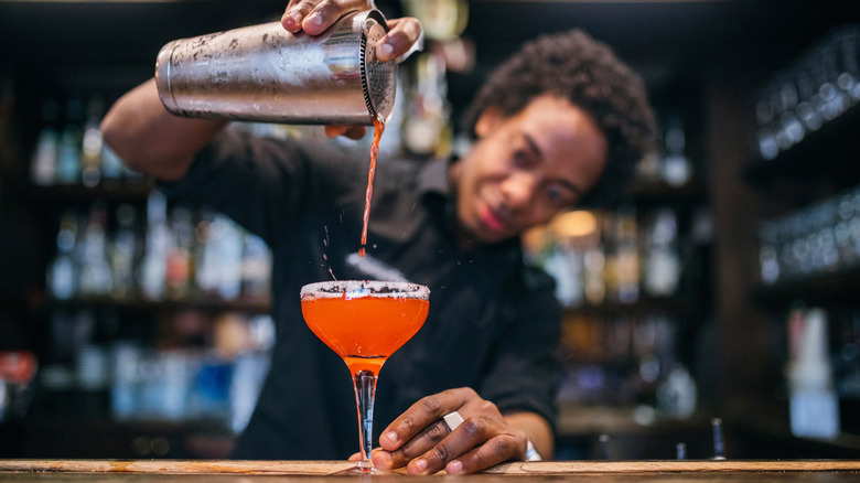 bartender pouring alcohol