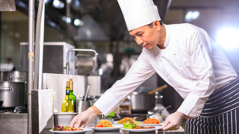 Chef plating a meal in the kitchen