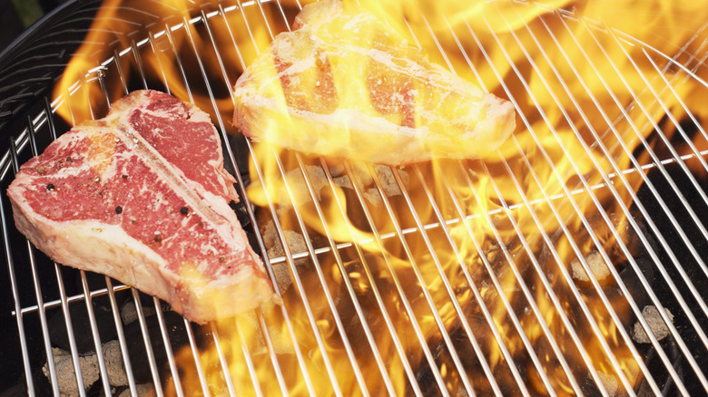 steaks cooking over open flame