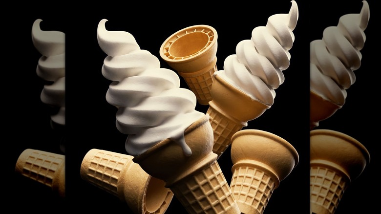 Several vanilla soft serve cones on black