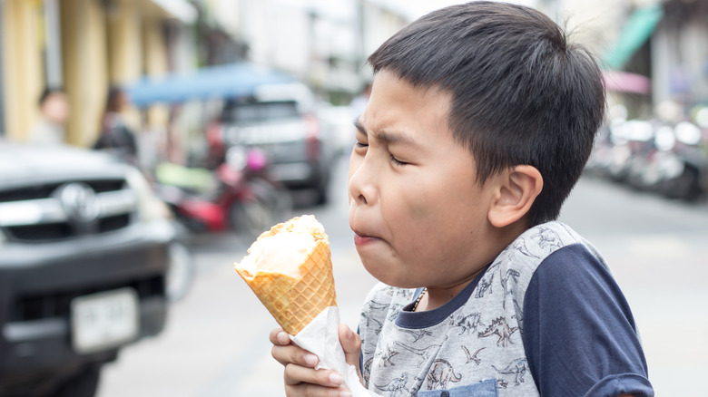 Young boy experiencing brain freeze