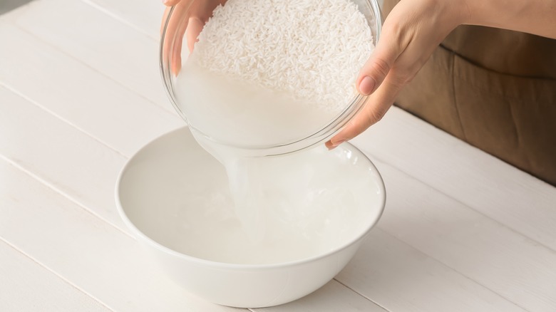 person washing rice before cooking