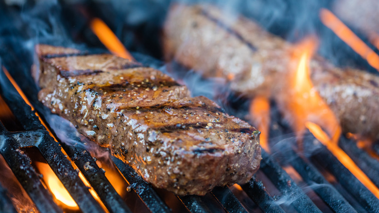 Steaks cooking on an outdoor grill