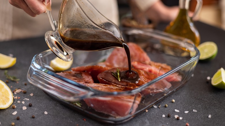 Pouring marinade over protein