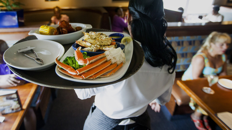 A waitress carrying a tray through Red Lobster