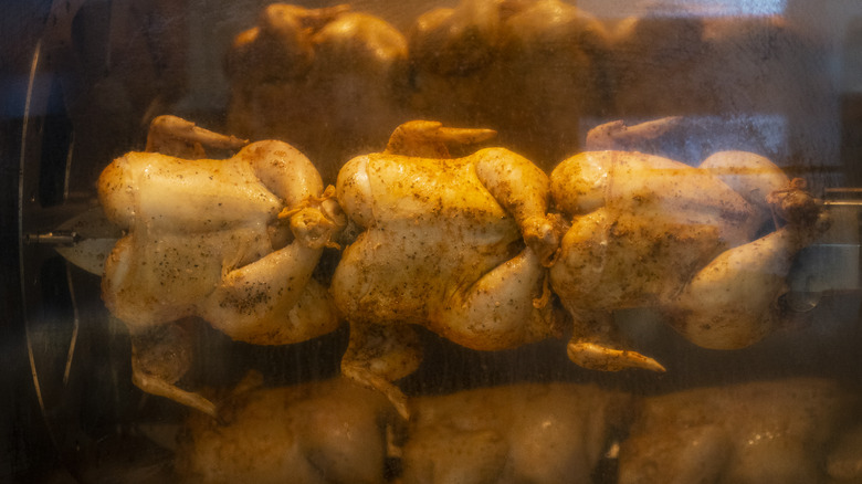 Chickens spinning in rotisserie 