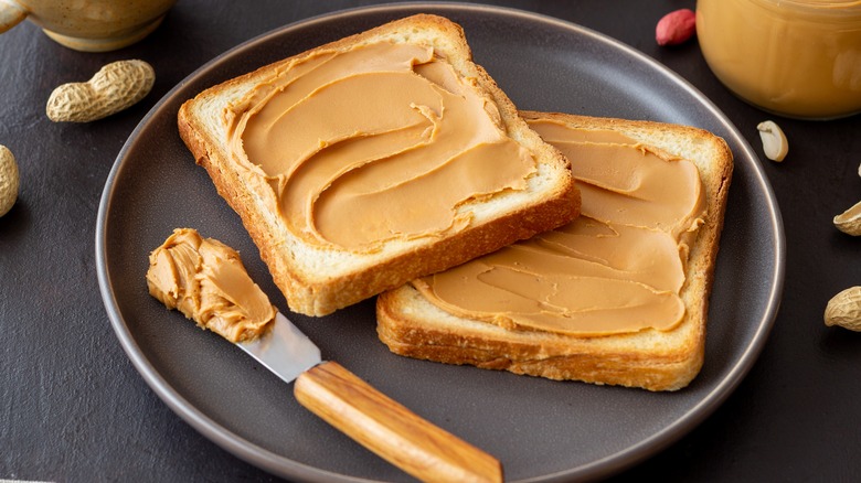 Opened peanut butter sandwich on plate