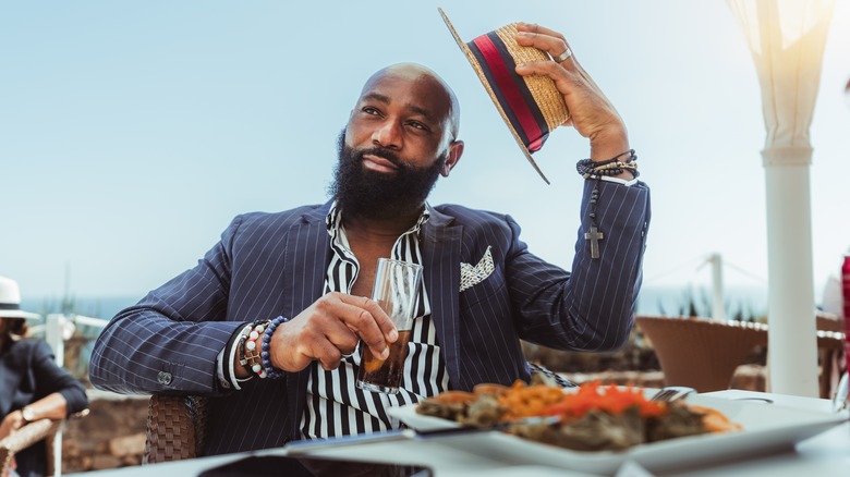 man eating at coastal restaurant