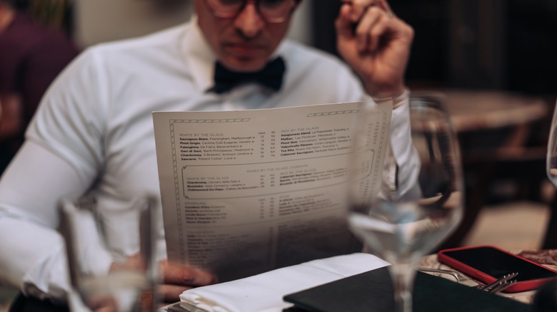 man looking at menu