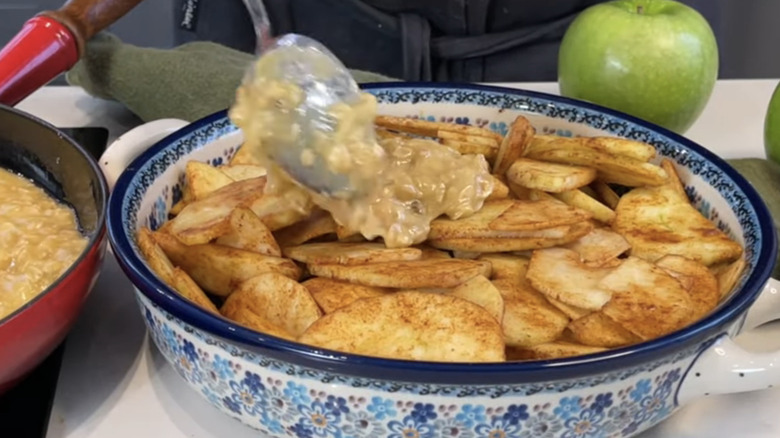 Spreading cake mix on apples