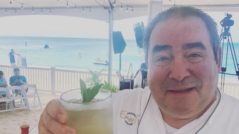 Emeril Lagasse holding a drink