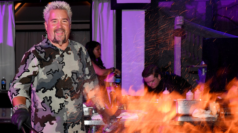 Guy Fieri with huge BBQ fire