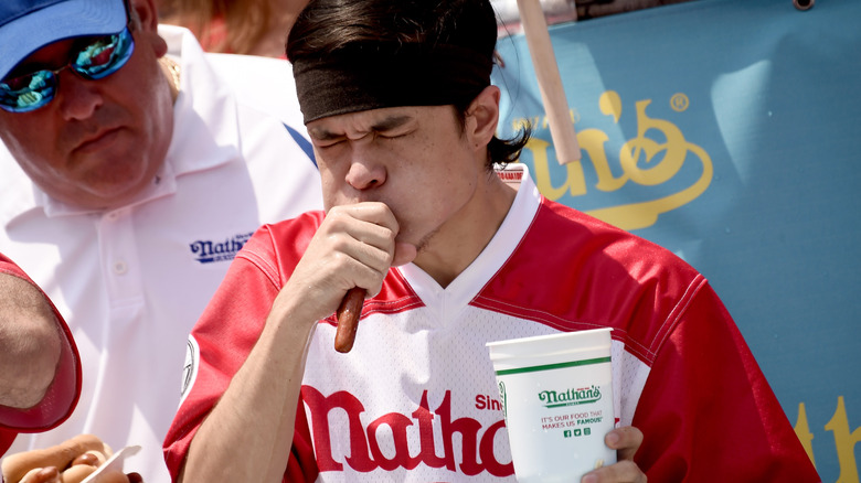 Matt Stonie eating a hot dog at a contest