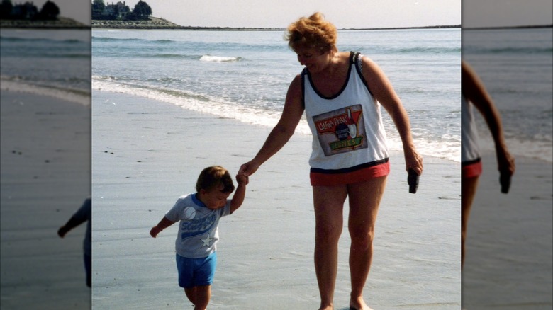 Matt Stonie as a young child holding his grandmother's hand at the beach