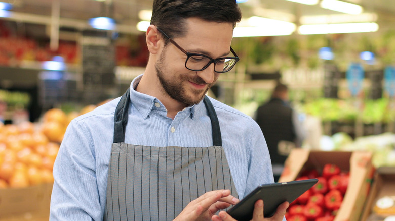 Supermarket manager smiling