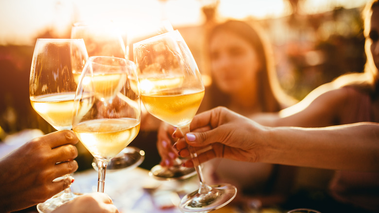 Diners clinging wine glasses