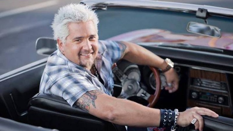 Guy Fieri in a car looking back