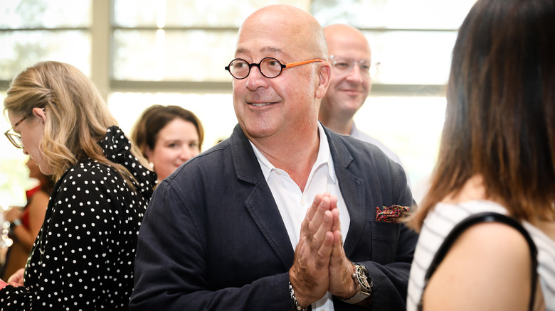 Andrew Zimmern smiling at an event