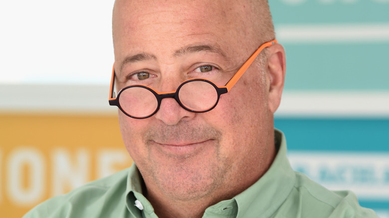 Andrew Zimmern smiling at camera