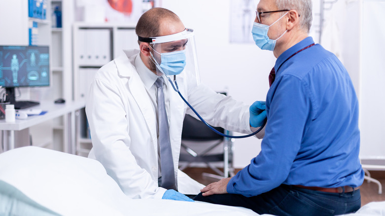 Doctor checking a patient's heart