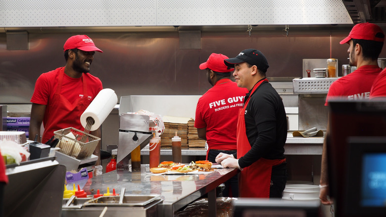 five guys employees in kitchen