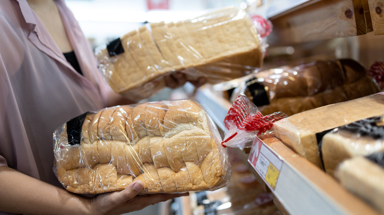 Person holding bread at store