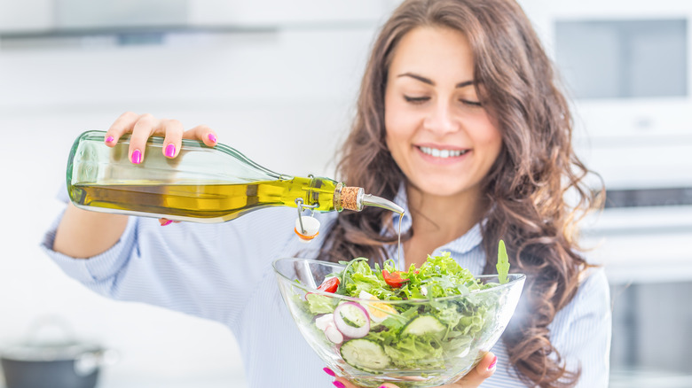 Olive oil poured into salad