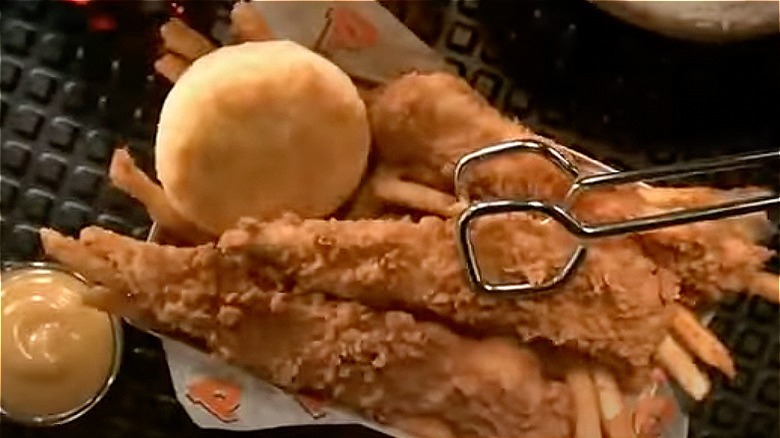 Fried chicken tender meal with tongs