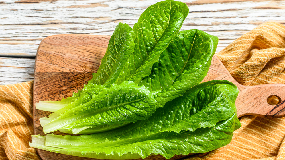 Romaine lettuce on a wooden cutting board