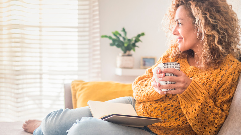 Woman smiling while drinking tea